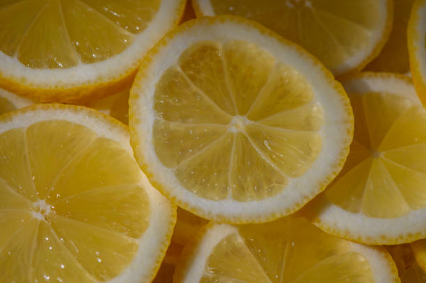 istock Bright yellow lemon slices arranged artistically on a surface, highlighting their refreshing citrus texture and color 2202094303