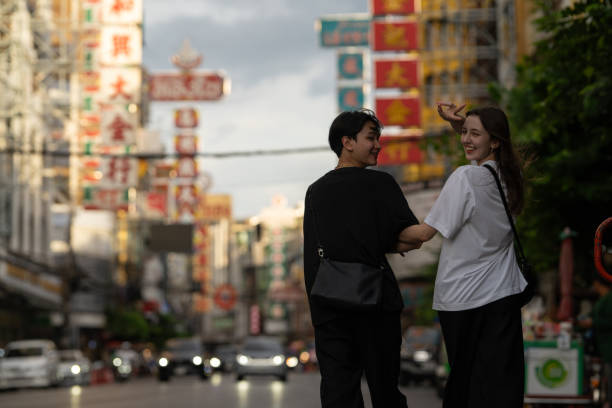 Multiracial couple dating and enjoying food and chinatown bangkok
