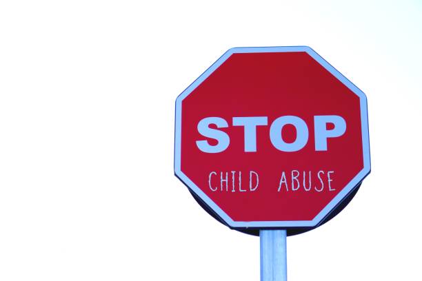 istock stop child abuse. global social issues. road sign with written words. 2202095807