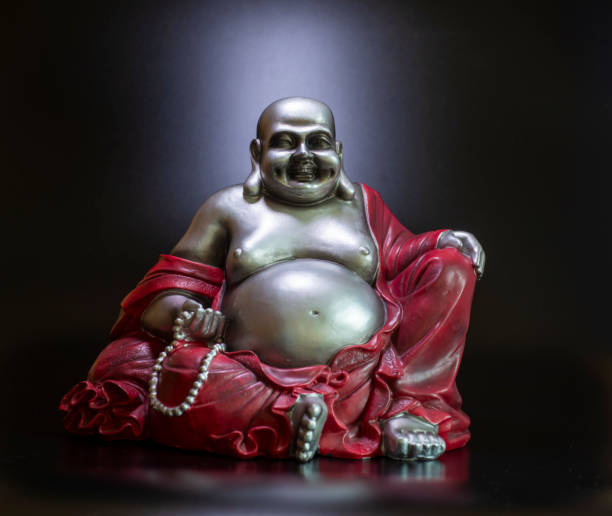 istock Buddha in atmospheric dark lighting with side light and selective focus 2202095842