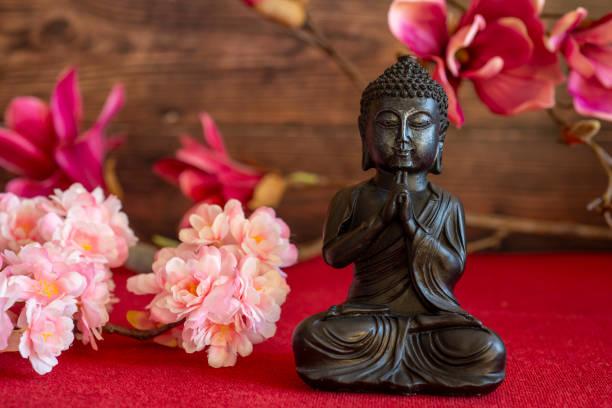 Buddha in atmospheric dark lighting with side light and selective focus