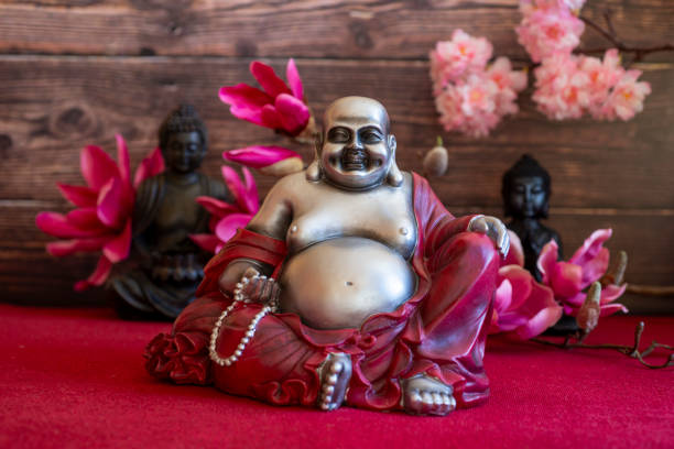 istock Fat happy laughing cozy buddha with flowers 2202095893