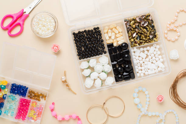 istock Tools and beads for making handmade jewelry on color background, top view 2202097901