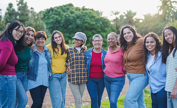 istock Group of multiracial women hugging each other at city park while smiling on camera - Multi generational diverse female friends outdoor - Community, social inclusion and feminism concept 2202098853