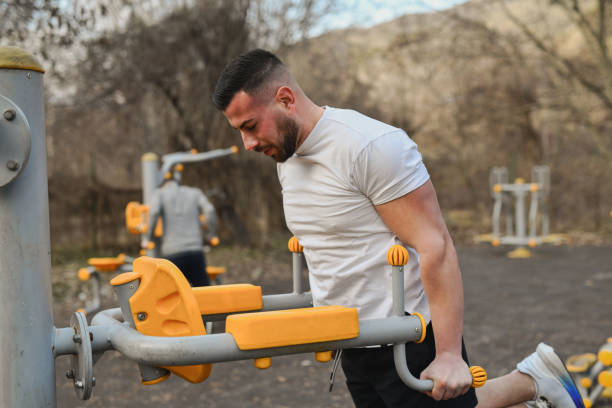 istock Sporty Male Doing Triceps Dips on Outdoors Exercise Machine Looking Focused 2202101112