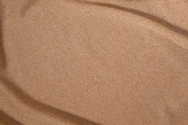 istock Texture of golden brown fabric. Abstract background 2202101286