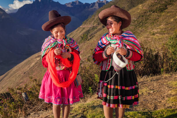 istock Peruvian women spinning wool by hand in Sacred Valley, Peru 2202101317