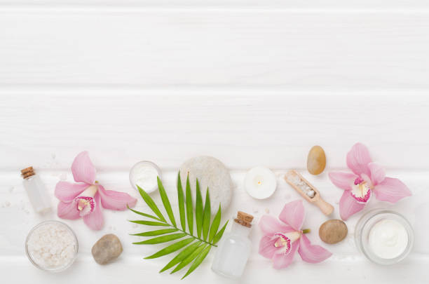 istock Composition with orchids, spa products on wooden background, top view 2202101324