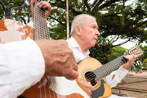 istock A latino man playing an acoustic guitar 2202101340