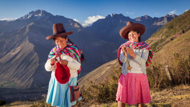 istock Peruvian women spinning wool by hand in Sacred Valley, Peru 2202101518