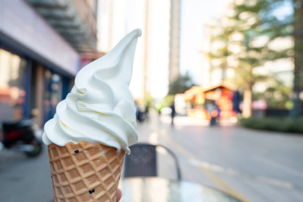 istock hand holding ice cream cone in the outdoor at horizontal composition 2202101681