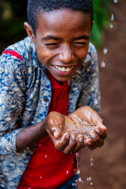 istock African young boy drinking fresh water, East Africa 2202103781