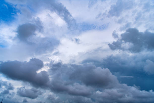 Dark clouds before rain on blue sky background.