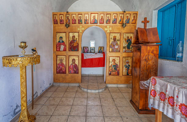 istock Rural Chapel Amidst Lush Greenery and Rolling Hills Under a Blue Sky, Crete 2202104719