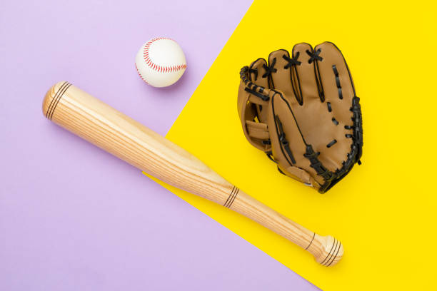 istock Baseball glove and bat with ball on color background, top view 2202105923