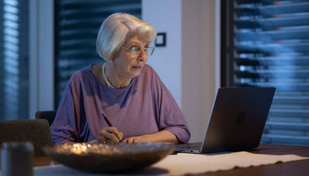 istock Senior Woman Working At Night On Laptop 2202105978