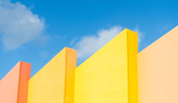 Modern futuristic architecture. Geometric shape. Modern building architecture against blue sky. Architectural geometrical detail. Exterior and facade. Geometric orange building design.