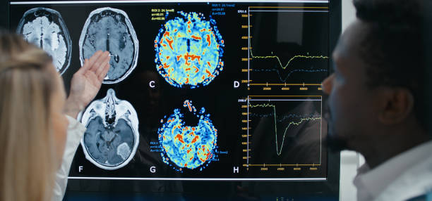istock Doctors review patient's skull x-ray, analyze each section closely, comparing it against normal patterns to identify any potential problems 2202107343