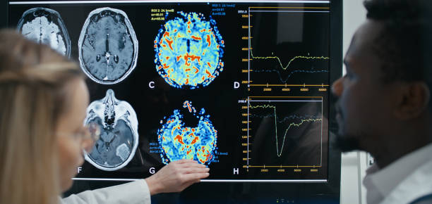 istock Doctor and assistant talk about skull x-ray, analyzing the details and any potential issues before surgery 2202107345