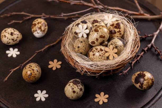 istock Quail eggs nest with spring decorations symbolizing new life 2202108135
