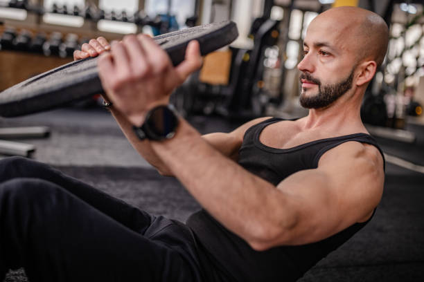 istock Determined Man Lifting Weight in Gym Environment 2202109799