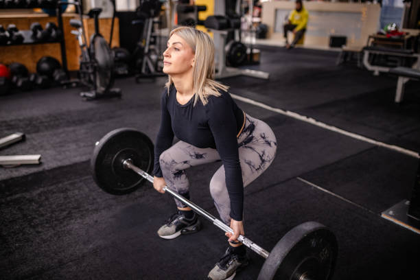 istock Dynamic Barbell Lift in Contemporary Gym 2202110072
