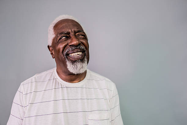 istock Senior man looking away on a studio shot with gray background 2202111053