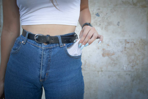 Young woman showing her empty pocket. No Money
