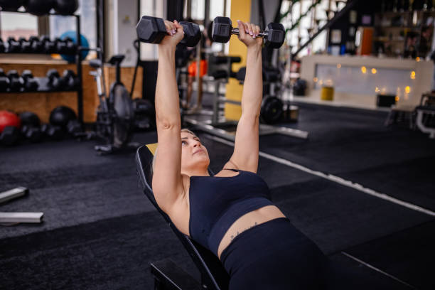 istock Focused Dumbbell Lifting in a Modern Gym Space 2202114421