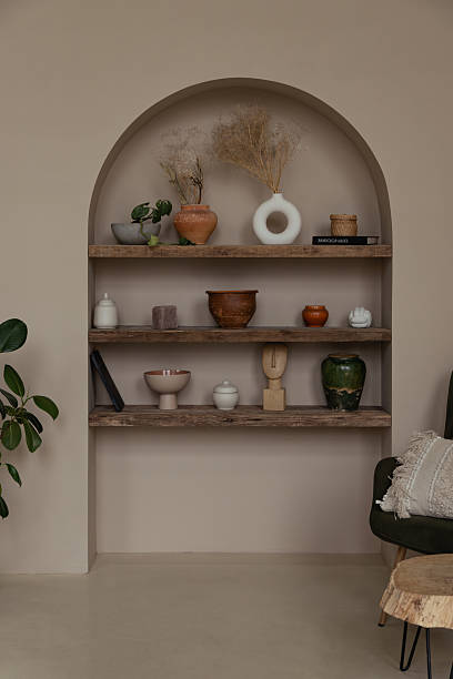 istock Wabi sabi built-in arch bookshelf with ceramic vases, pots and decor 2202115238