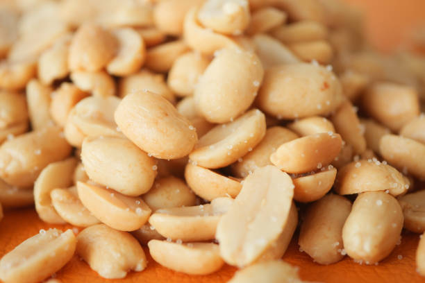 istock This is a CloseUp Image of Shelled Peanuts on a Beautifully Designed Wooden Surface 2202115458