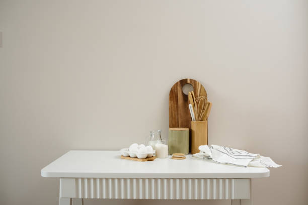 istock A curated collection of kitchen utensils and fresh ingredients: eggs, milk, sugar, cutboard, napkin is elegantly displayed on a neutral white table. 2202115654