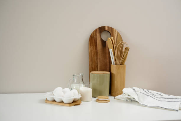 istock A curated collection of kitchen utensils and fresh ingredients: eggs, milk, sugar, cutboard, napkin is elegantly displayed on a neutral white table. 2202115725