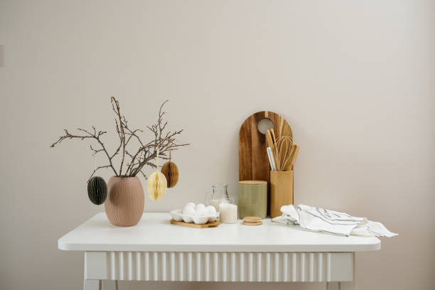 istock A curated collection of kitchen utensils, vase with dry branches and easter eggs and fresh ingredients: eggs, milk, sugar, cutboard, napkin is elegantly displayed on a neutral white table. 2202116001