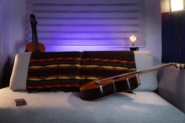 istock Cozy music corner with guitars and cool lighting. Purple light 2202116217