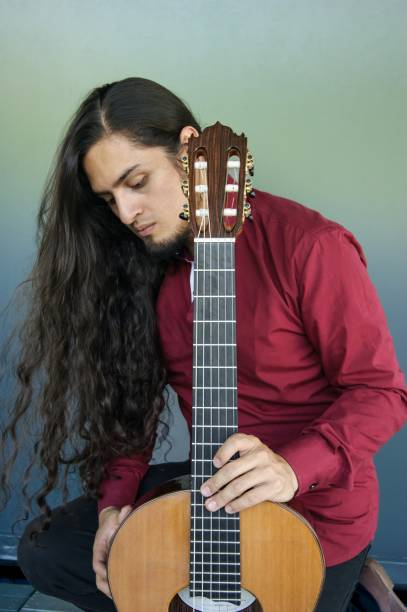 istock Thoughtful Musician with Classical Guitar in Contemplative Pose 2202116546