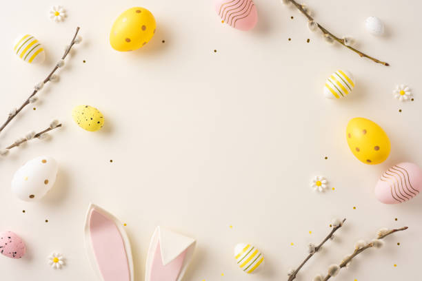 istock Decorative arrangement featuring Easter eggs, bunny ears, willow branches, and flowers for spring celebrations 2202118157