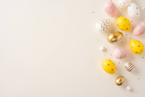istock A festive layout of golden, yellow, and pastel-colored decorated Easter eggs on a neutral background conveying joy and celebration 2202118161