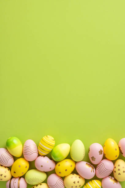 istock Decorative vertical pastel Easter eggs displayed against a green backdrop, evoking a festive and celebratory atmosphere with vibrant colors and cheerful ornamentation for holiday-themed designs 2202118169