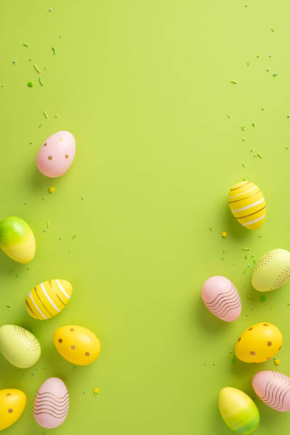 istock Colorful vertical painted Easter eggs arranged on a green background with seasonal decorations, perfect for holiday themes 2202118176