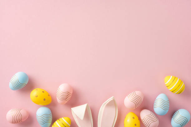 istock Easter eggs creatively arranged with decorative colors and patterns on a pastel pink backdrop 2202118181