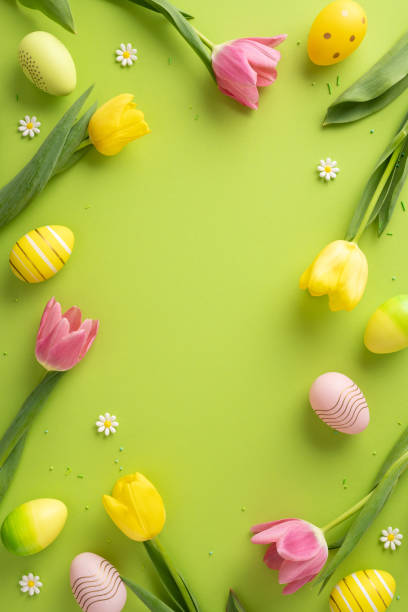 istock Colorful vertical Easter setup featuring tulips, decorative eggs, daisies, and greenery against a vibrant green background. Ideal for festive, celebration, and spring-related contexts 2202118200
