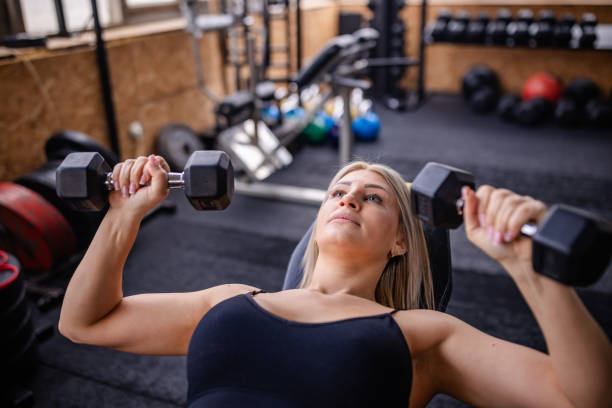 istock Focused Workout with Dumbbells in Fitness Studio 2202120067