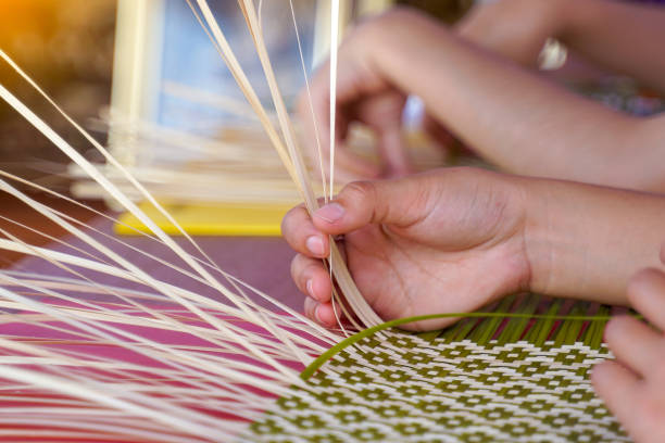 woven bamboo art texture close up.  weaving art patterns using bamboo combined with green, red and purple