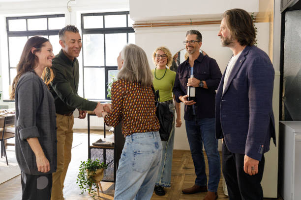 istock Cheerful Guests Arriving at a Loft Dinner Party | Friendship & Celebration 2202123588