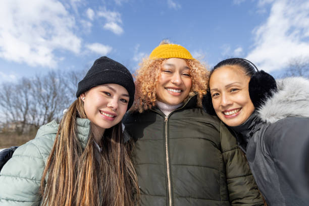 istock Beautiful diverse friends spend winter day outdoors together 2202124505