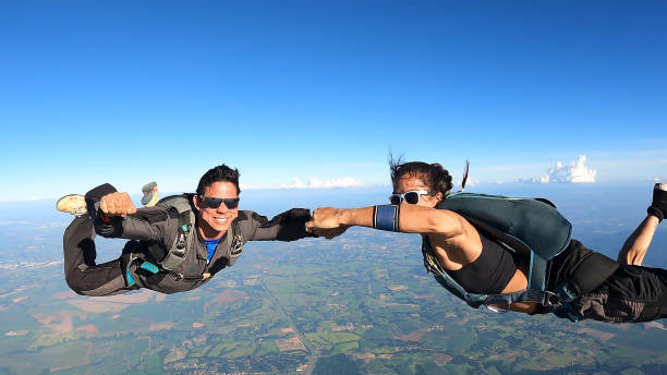 istock A heterosexual couple of skydivers kiss while free falling 2202125321