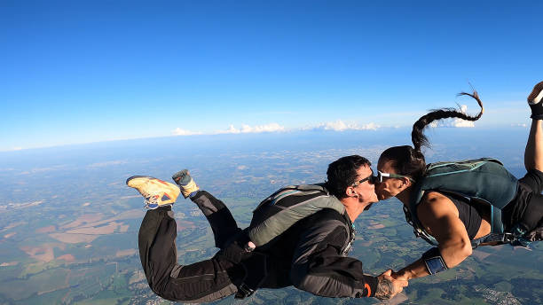 istock A heterosexual couple of skydivers kiss while free falling 2202125459