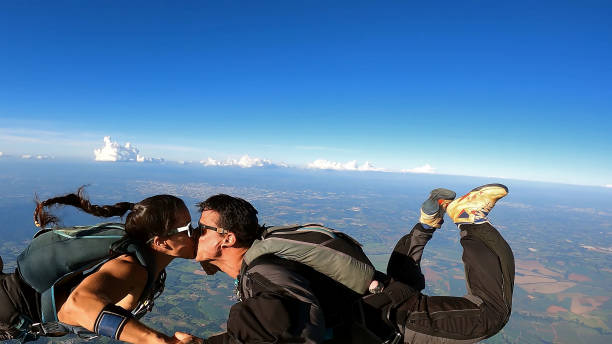 istock A heterosexual couple of skydivers kiss while free falling 2202125688