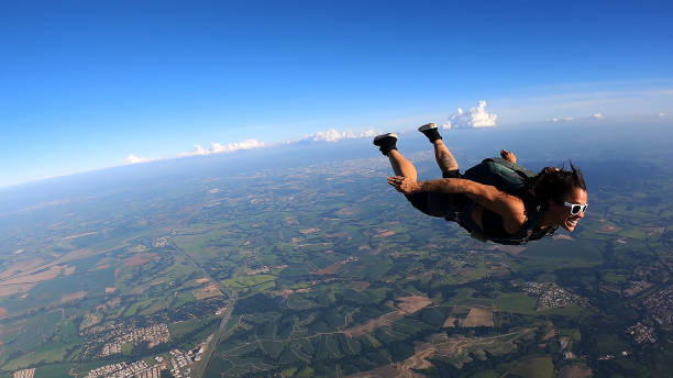 A Brazilian skydiver in free fall, on a summer day. Smiling and confident.